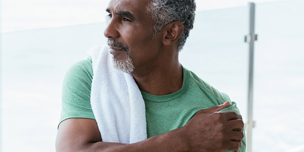 Individual experiencing shoulder pain