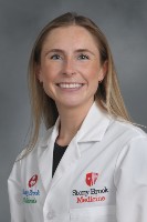 Meagan Hartough, NP in a white coat