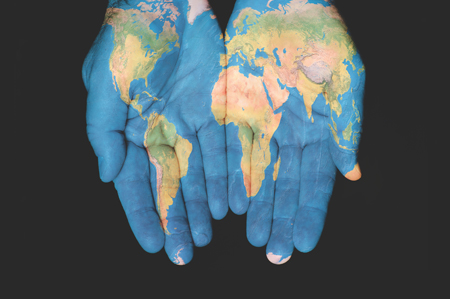 world map painted on hands